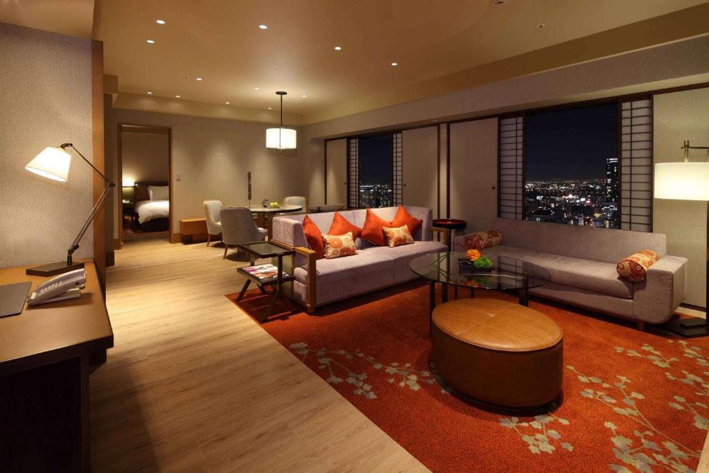 a living room with a couch and a table at Hilton Osaka Hotel in Osaka