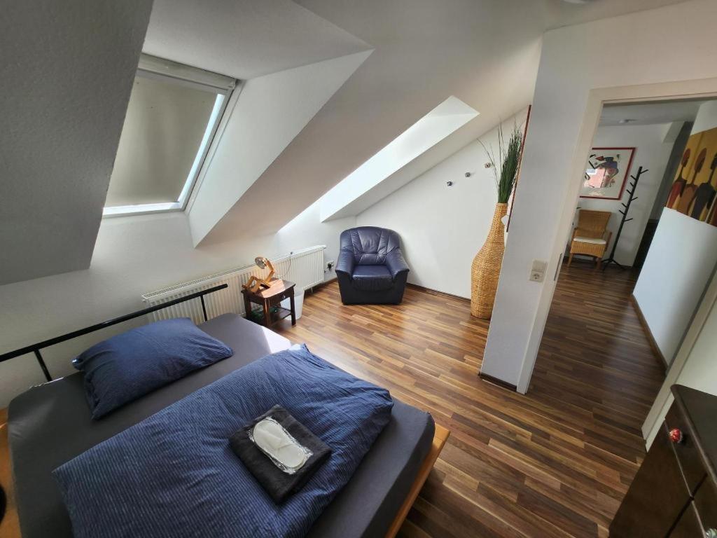 a bedroom with a bed and a living room at Tolle Wohnung in zentraler Lage in Neu-Ulm in Neu Ulm