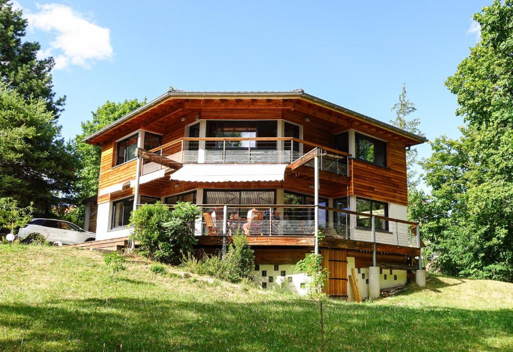 a large wooden house on top of a hill at Maison Cozy de Gap in Gap