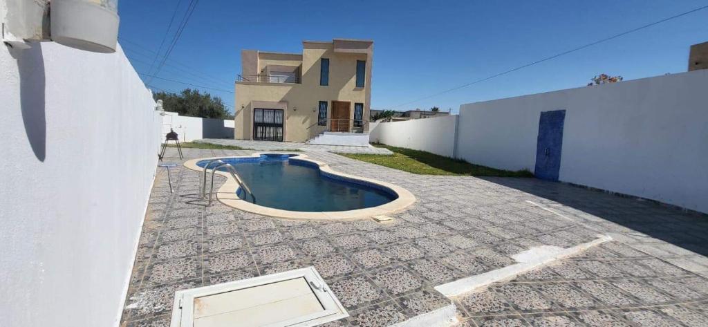 uma pequena piscina no meio de um quintal em Villa Amine khazroun em Midoun