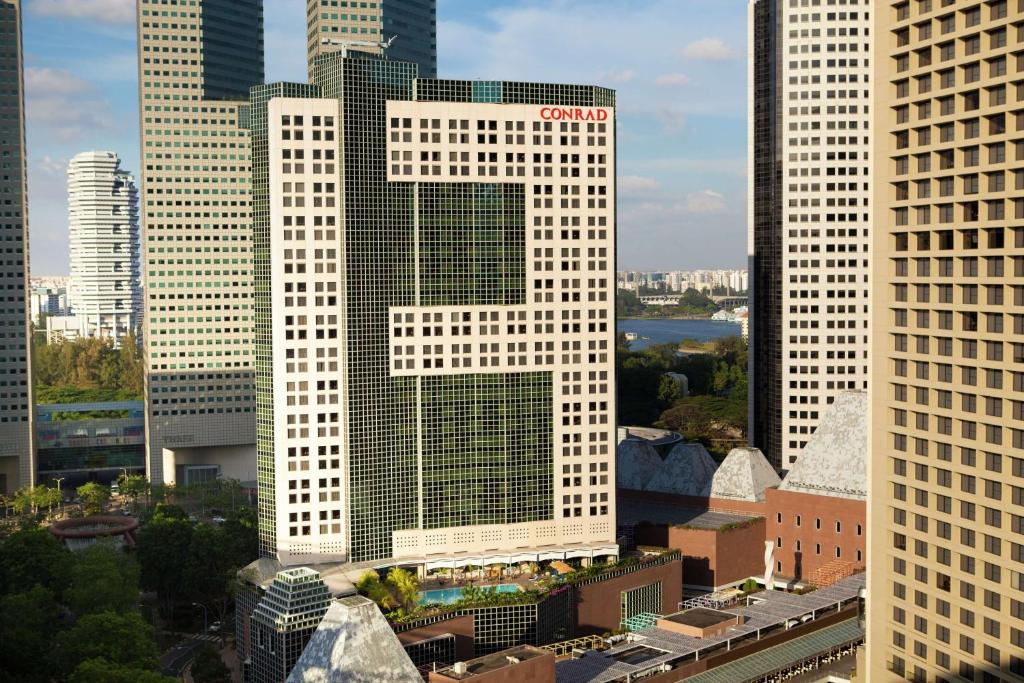 Conrad Centennial Singapore في سنغافورة: مبنى أبيض طويل مع حرف x عليه