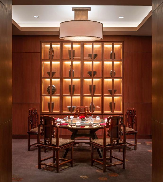 a dining room with a table and chairs at Conrad Bangkok in Bangkok