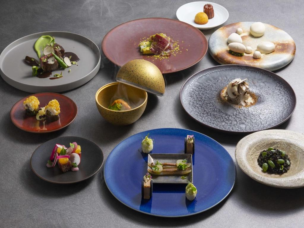 a group of plates of food on a table at Conrad Osaka in Osaka