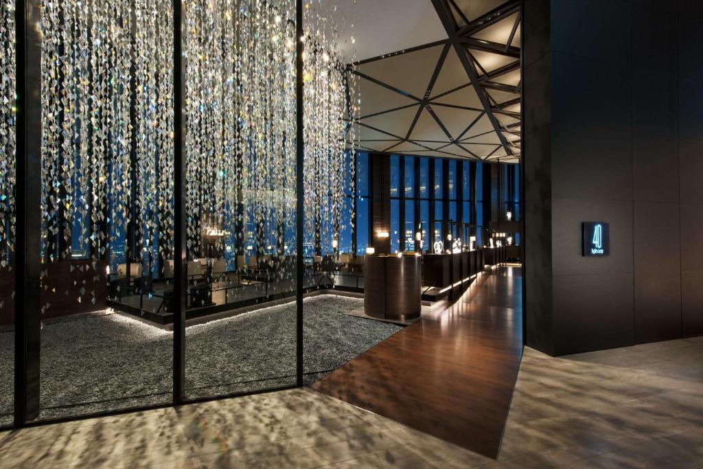 a lobby with a wall of christmas lights at Conrad Osaka in Osaka