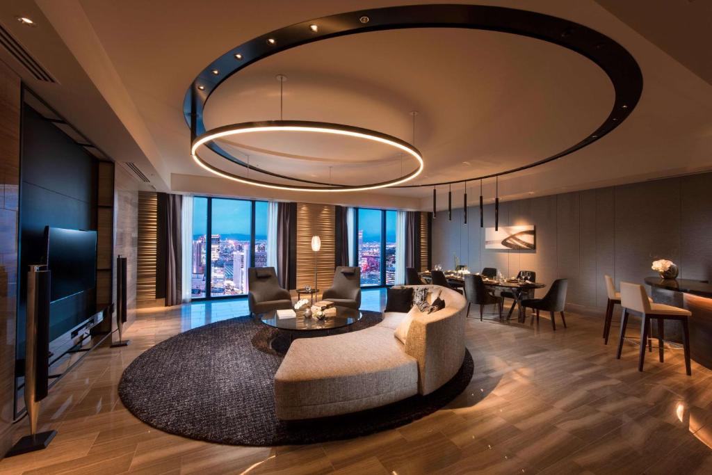 a living room with a couch and a table at Conrad Osaka in Osaka