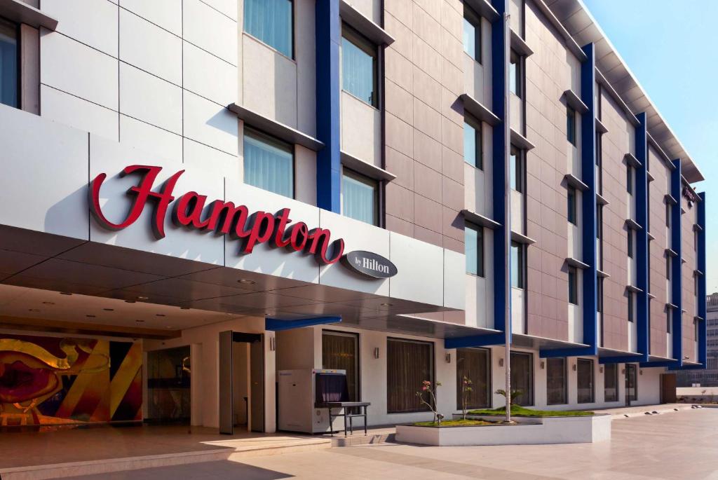 a sign on the front of a hotel at Hampton by Hilton Vadodara-Alkapuri in Vadodara