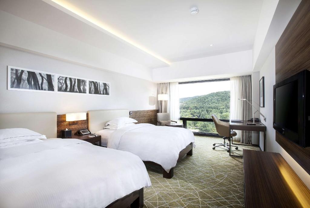 Postel nebo postele na pokoji v ubytování Hilton Gyeongju