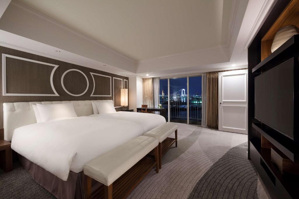 a large bedroom with a large bed and a television at Hilton Tokyo Odaiba in Tokyo