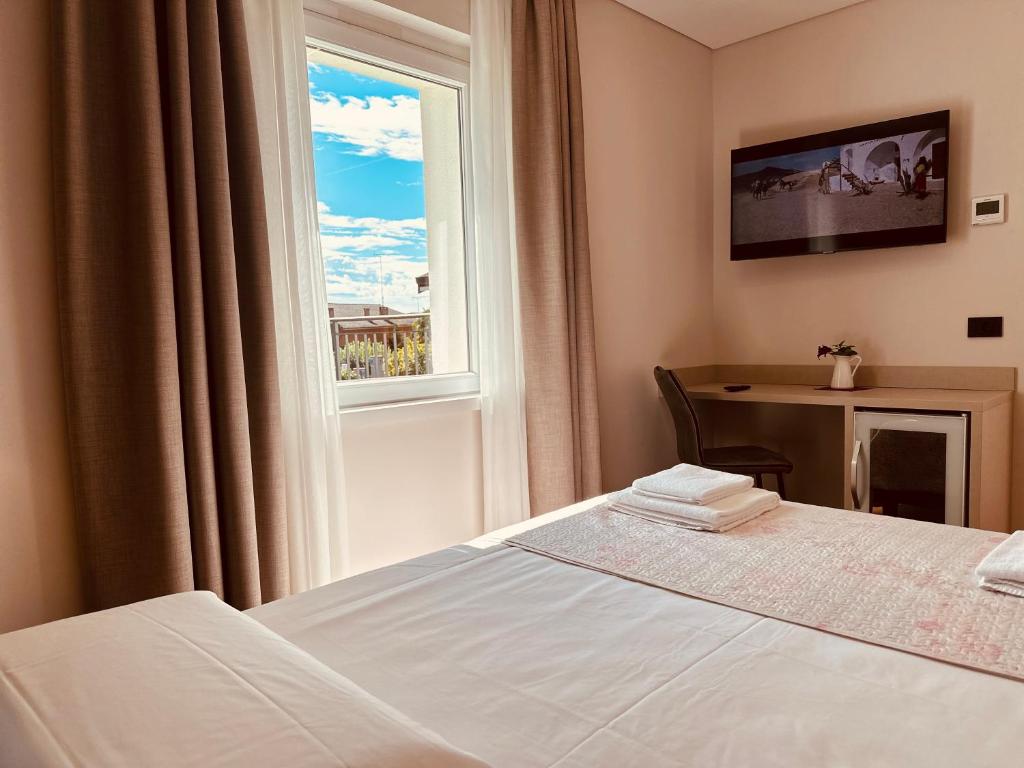 Postel nebo postele na pokoji v ubytování Hotel Riviera