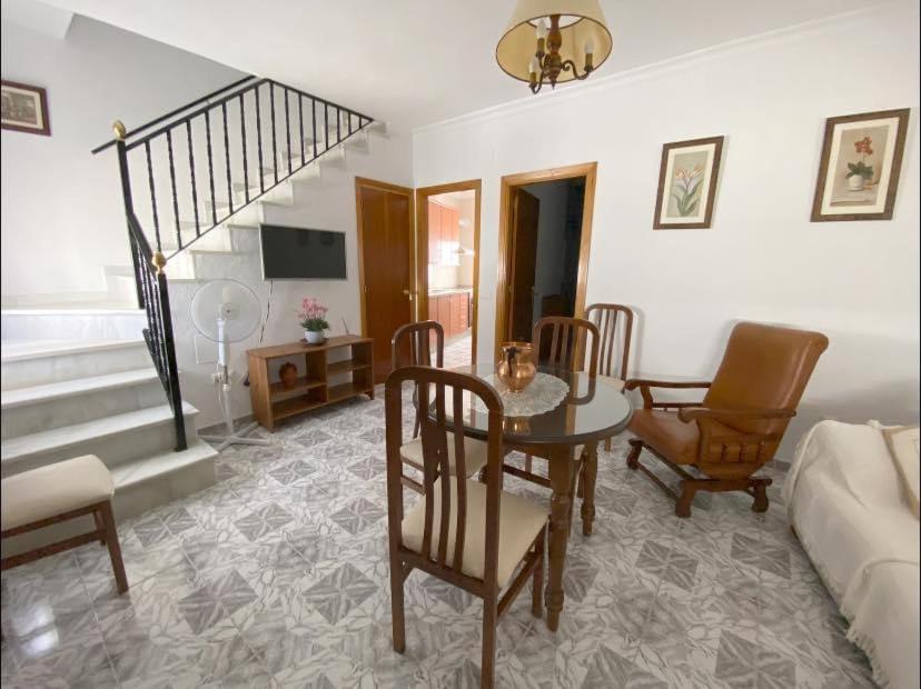 un soggiorno con tavolo, sedie e divano di Casa “El Zumaque” en Zahara de la Sierra a Zahara de la Sierra