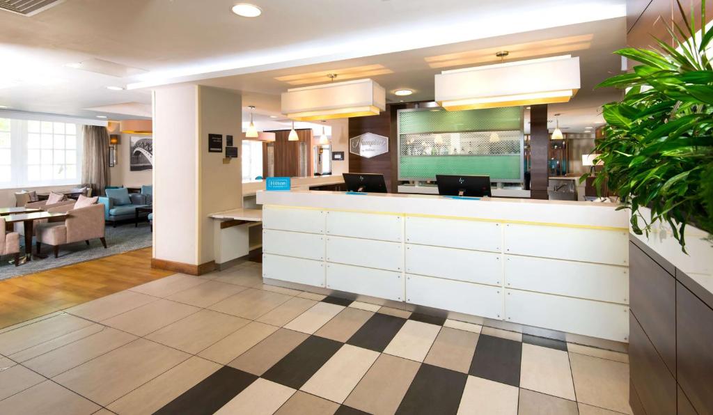 a lobby of a hospital with a reception counter at Hampton by Hilton Birmingham Jewellery Quarter in Birmingham
