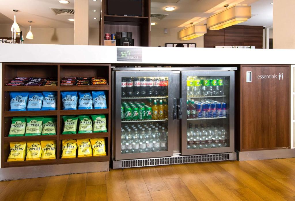 a refrigerator filled with lots of drinks in a store at Hampton by Hilton Birmingham Jewellery Quarter in Birmingham