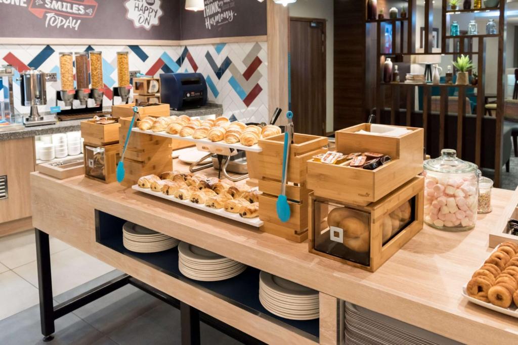 a bakery with donuts on a counter in a store at Hampton by Hilton Birmingham Jewellery Quarter in Birmingham