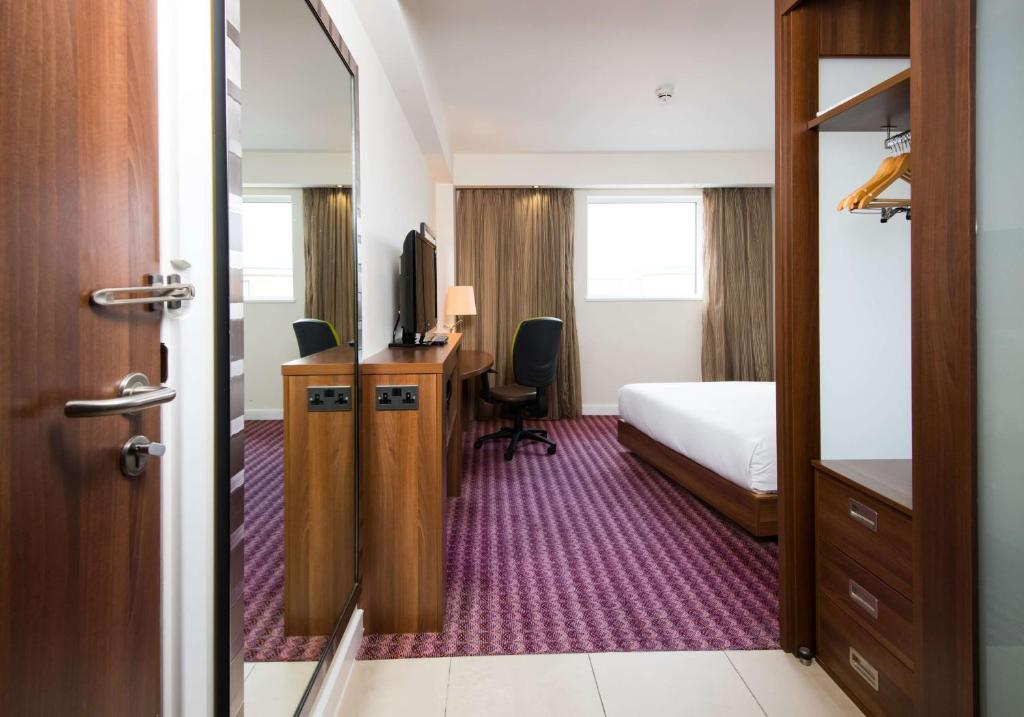 a hotel room with a bed and a television at Hampton by Hilton Birmingham Jewellery Quarter in Birmingham