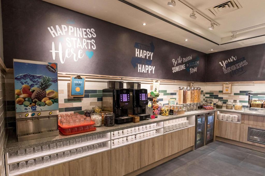 a fast food restaurant with a happy anniversary sign on the wall at Hampton by Hilton Bournemouth in Bournemouth
