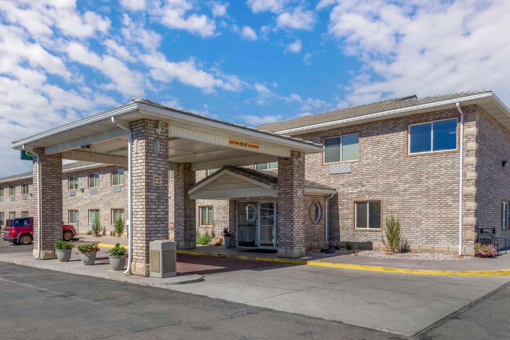 a large brick building with a parking lot at Quality Inn & Suites Fillmore I-15 in Fillmore