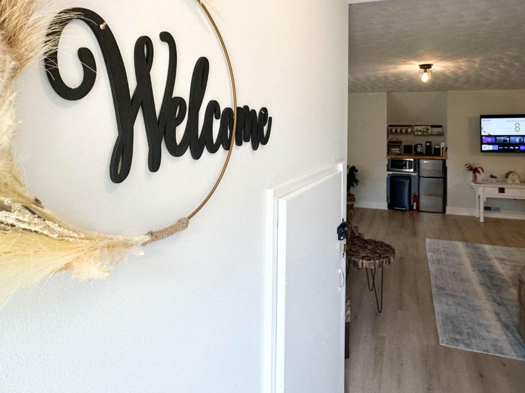 a welcome sign on the wall of a living room at Dreamy Boho Remodeled Cottage with Mountain Views in Sparta
