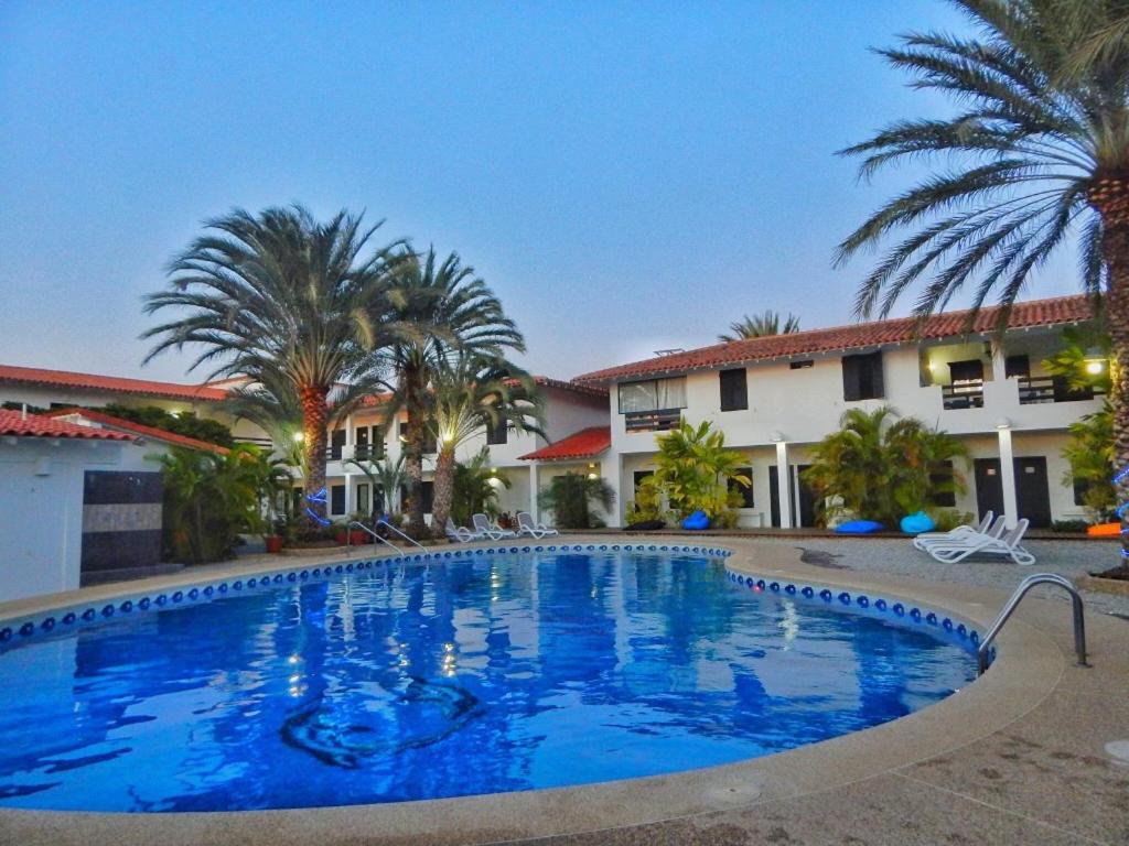 a large swimming pool in front of a hotel at POSADA RANCHO DELFIN in El Yaque