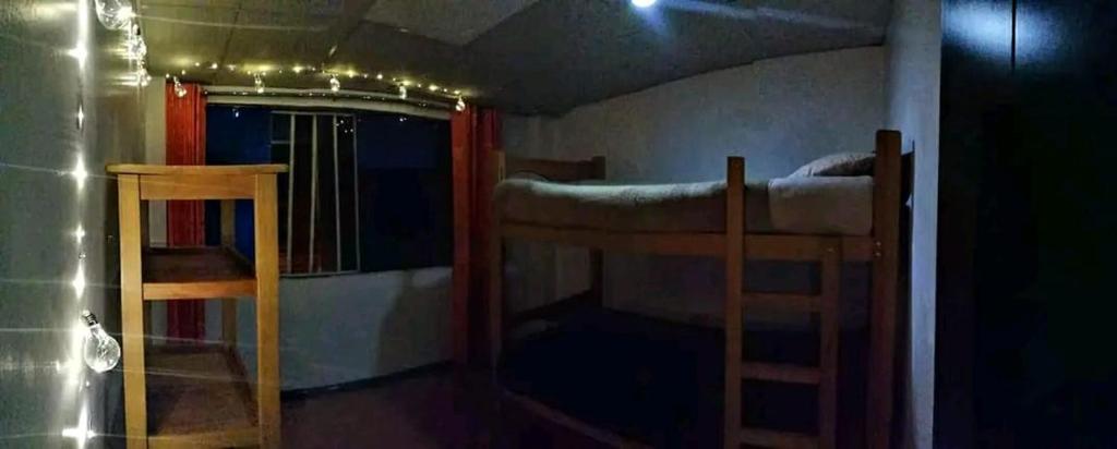 a room with two bunk beds and a mirror at Siren's House in Cusco
