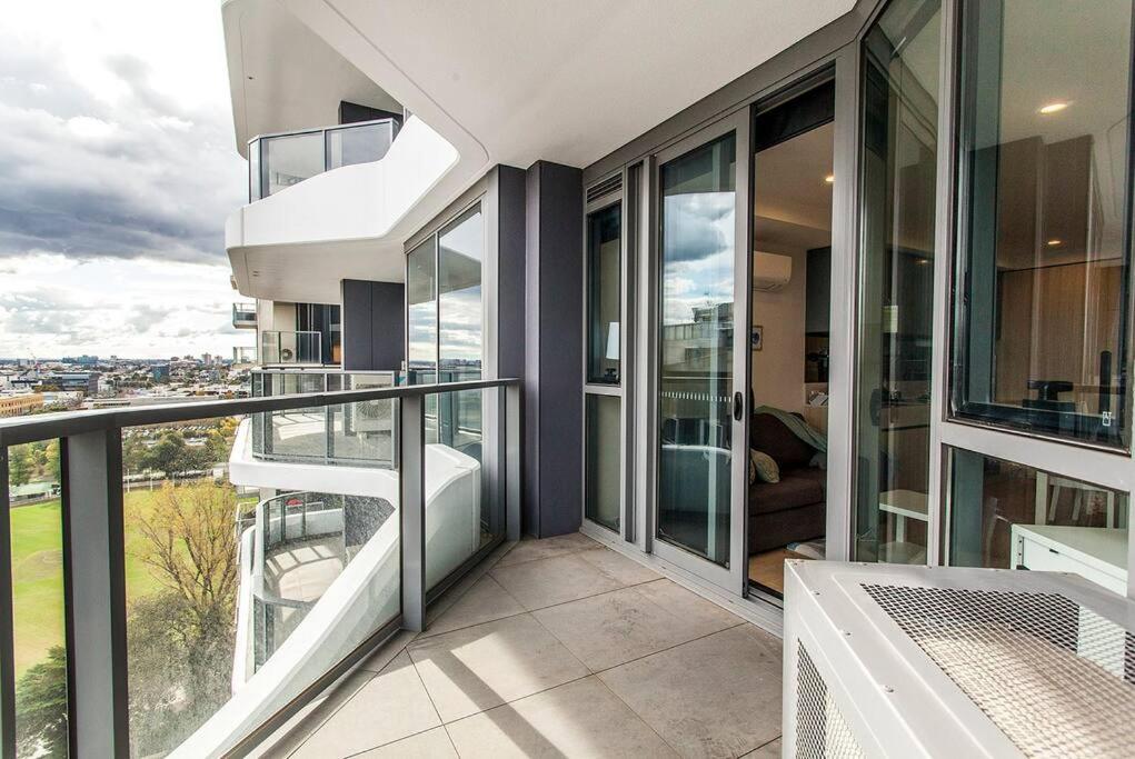 a balcony of a house with glass doors and a view at 2 Bed Apt with CAR Parking in SouthYarra（TF150221） in Melbourne