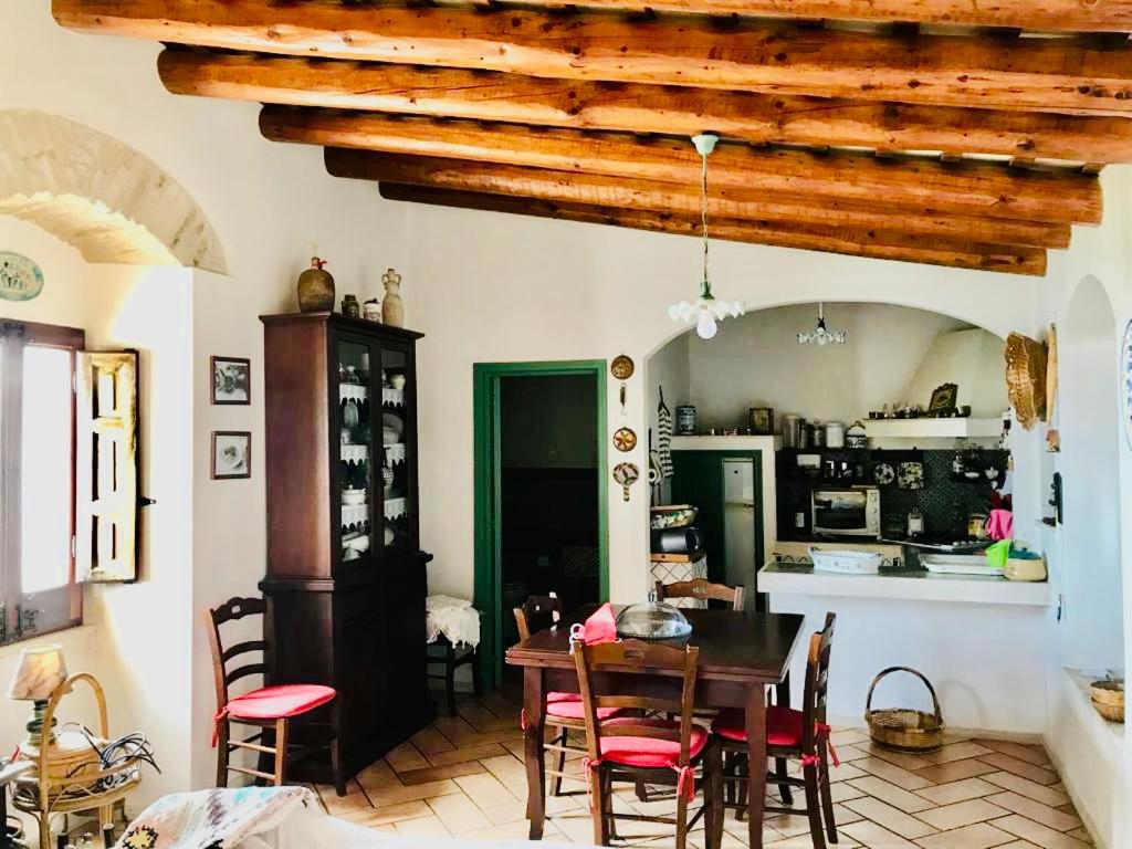 a kitchen and dining room with a table and chairs at Cortile Padre Vincenzo in Erice