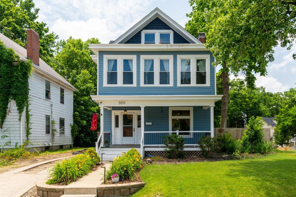 a blue and white house with a yard at Modern Oakley Retreat - King Bed - Free Parking - Centrally Located in Cincinnati