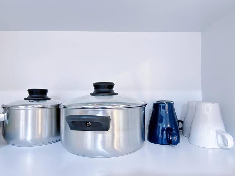 a counter with two pots and a crockpot and a blue container at TheSun #3BR #PISA #FTZ #FamilyStay #USM in Bayan Lepas