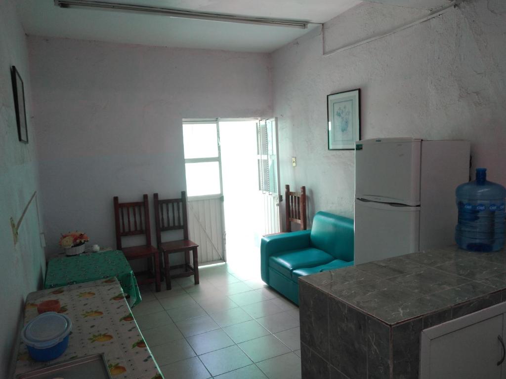 a kitchen and living room with a refrigerator and a couch at Habitaciones amuebladas. Poliforum/Centro in León