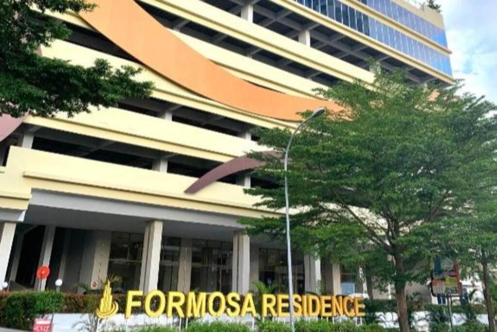 a tall building with a sign in front of it at Formosa Residence Nagoya, 2 Bedroom, Batam City in Nagoya