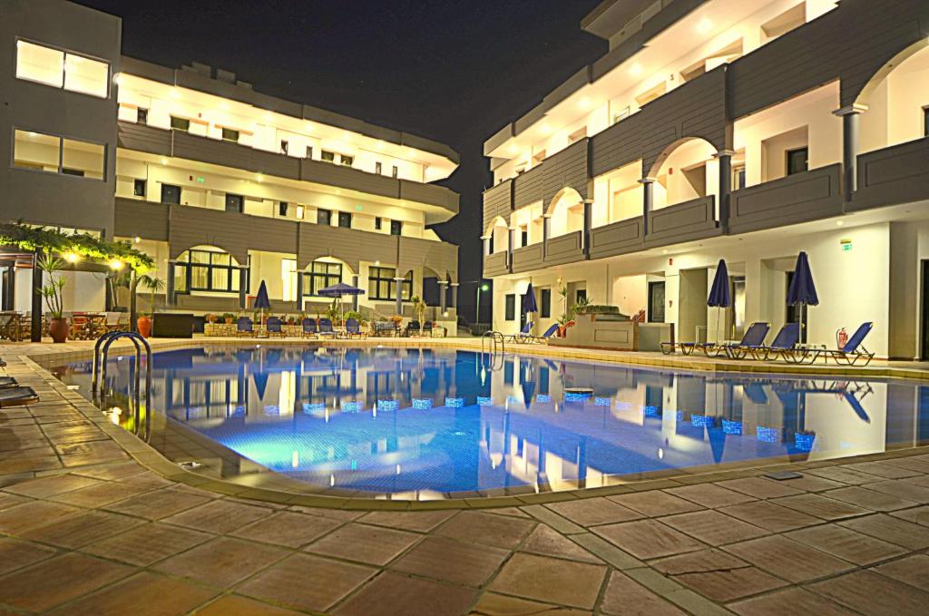 a large swimming pool in front of a building at Christina Beach Hotel in Kissamos