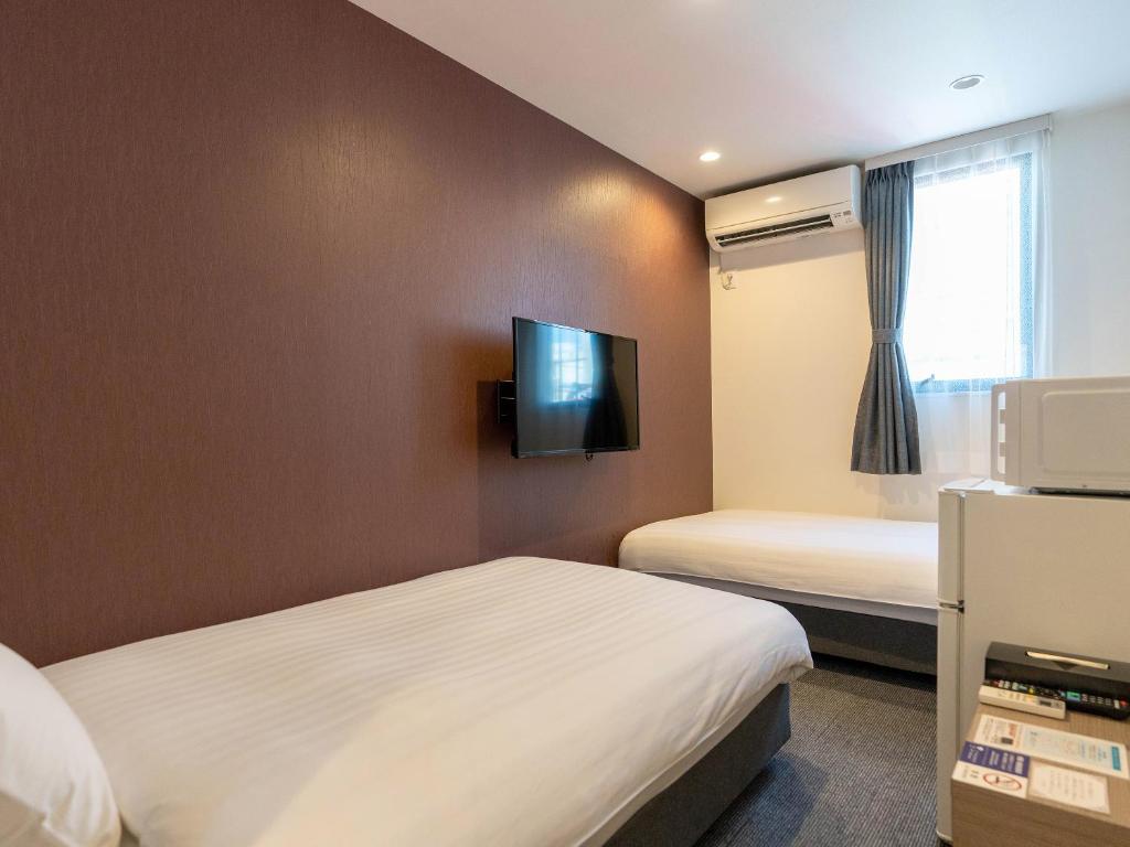 Postel nebo postele na pokoji v ubytování HOTEL R9 The Yard Mokainter