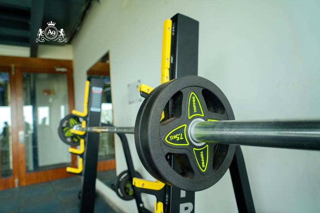 a barbell in a gym with other equipment at Hotel A9 Barnala in Barnāla