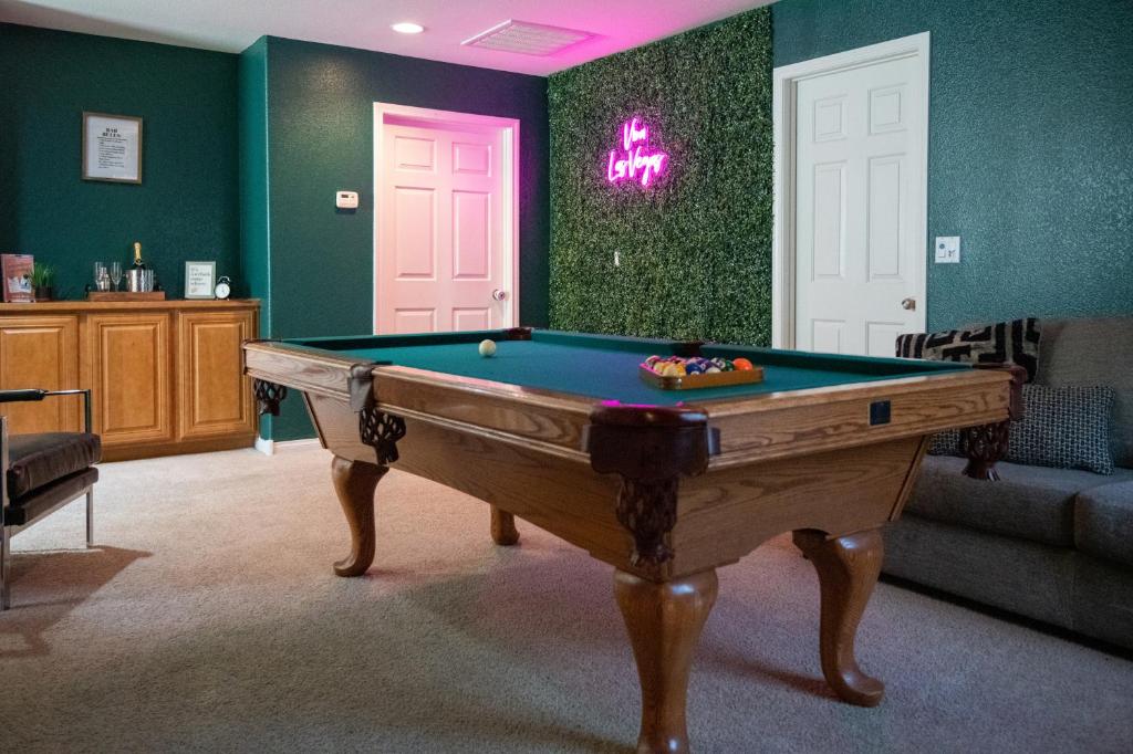 a living room with a pool table in front of a door at Large 3BR King Suite Moments Away From Strip in Las Vegas
