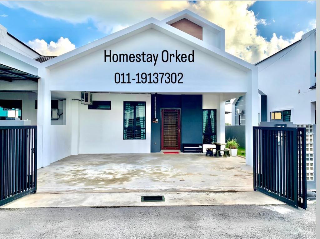 a white house with a sign that reads homesteadery united at ORKED HOMESTAY in Alor Setar