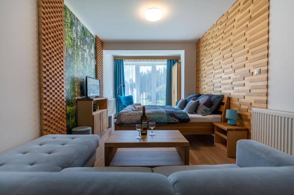 a living room with a bed and a couch at Apartmán Mirka in Liptovský Ján