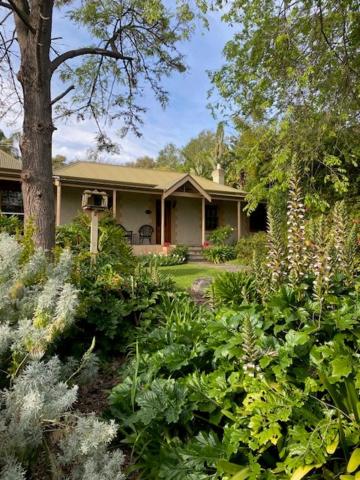 a house with a garden of plants in front of it at Cole-Brook Cottage Historic House in McLaren Vale