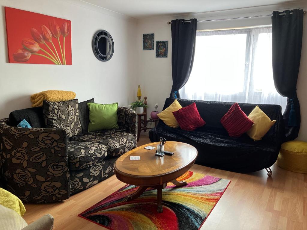 a living room with a couch and a table at Dundee City Waterfront, 2 Bedroom 2 Bathroom Apartment - short walk to V and A, Bus & Train Stations in Dundee