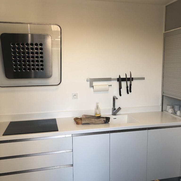 a kitchen with a sink and a microwave at Penthouse 120 m2 vue imprenable Lattes in Lattes