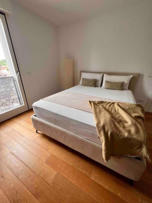 a bedroom with a bed with a blanket on it at Casa Capelute in Udine