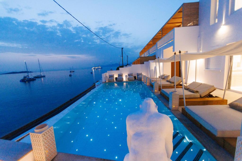 a swimming pool with a view of the water at Icon Mykonos in Megali Ammos