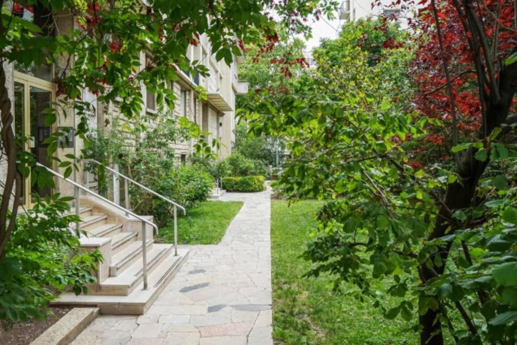 a walkway in front of a building at Luxury modern two bedroom duplex by Roland Garros in Paris