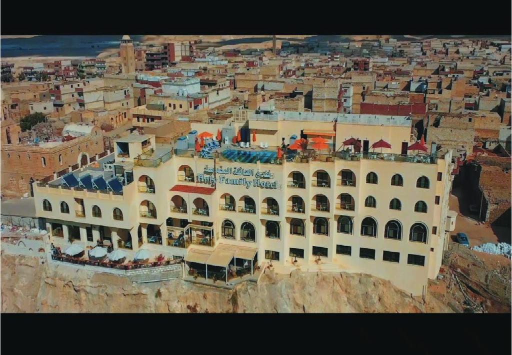a large building on the side of a cliff at Holy Family Hotel in Jabal aţ Ţayr