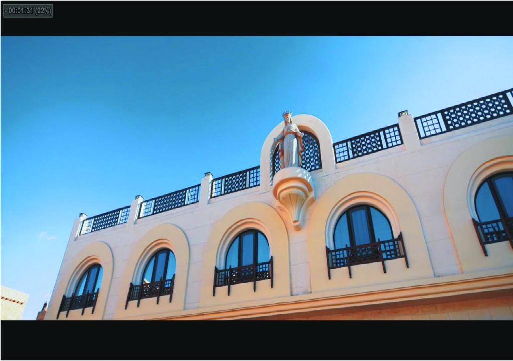 a white building with windows on top of it at Holy Family Hotel in Jabal aţ Ţayr