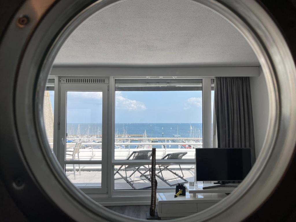 einen Spiegel in einem Zimmer mit Blick auf einen Balkon in der Unterkunft Ferienwohnung Fördedeck in Kiel