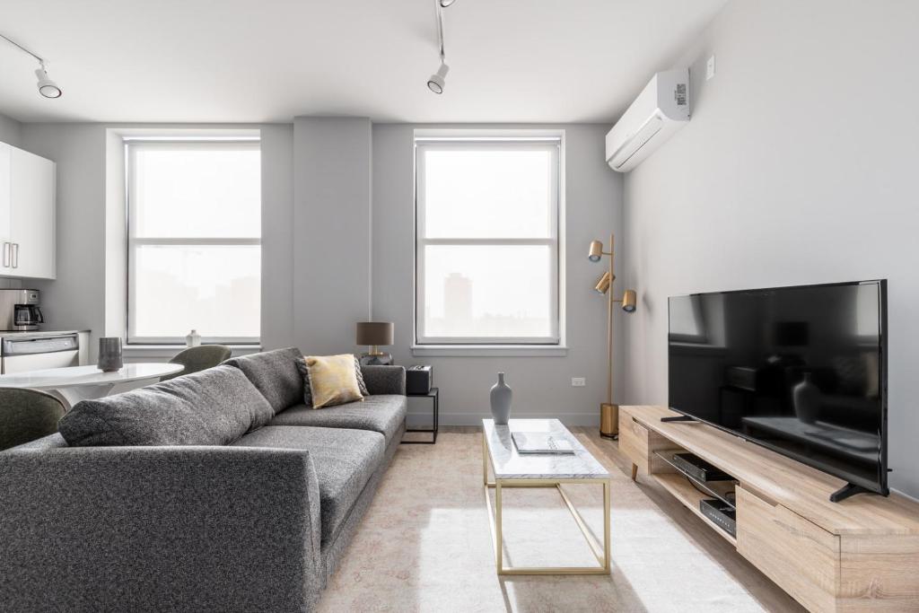 a living room with a couch and a flat screen tv at Loop 1BR w Fitness center nr W Loop the L CHI-194 in Chicago