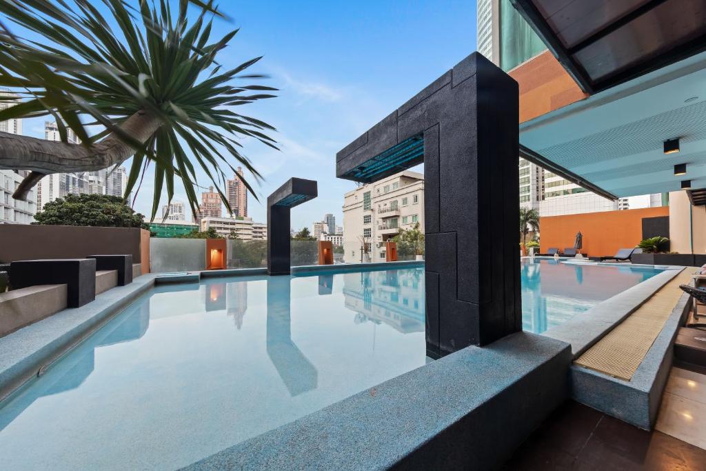 a swimming pool on the roof of a building at The Mandison Bangkok - Formerly Golden Tulip Mandison Suites in Bangkok