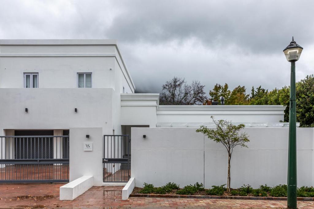 a white building with a street light next to it at Villa Stellenbosch in Stellenbosch