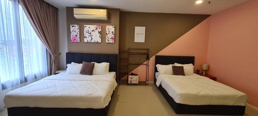 a bedroom with two beds in a room at Arcoris Mont Kiara 163 in Kuala Lumpur