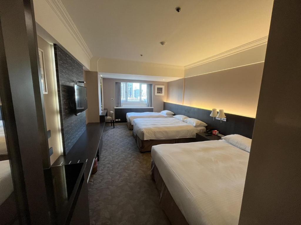 Postel nebo postele na pokoji v ubytování Guide Hotel Kaohsiung Liuhe