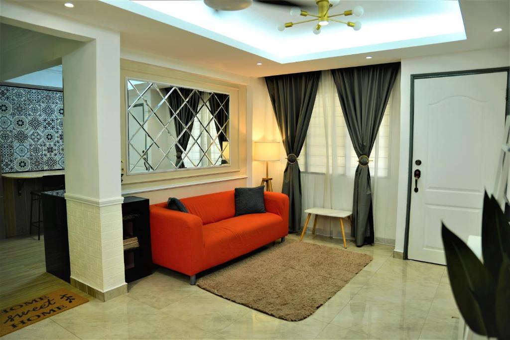 a living room with a red couch and a window at Awedee Homestay Putrajaya in Putrajaya